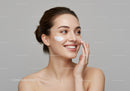 Happy Young Woman Applying Skincare Cream in Beauty Routine