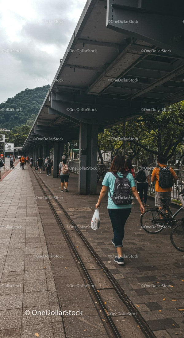 Busy Urban Street Scene with Pedestrians and Bicycle under Overpass