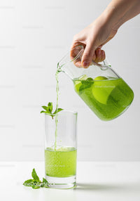 Refreshing Green Mint Drink Poured from Glass Pitcher