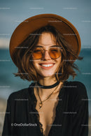 Smiling Woman Wearing Straw Hat and Sunglasses at Beach