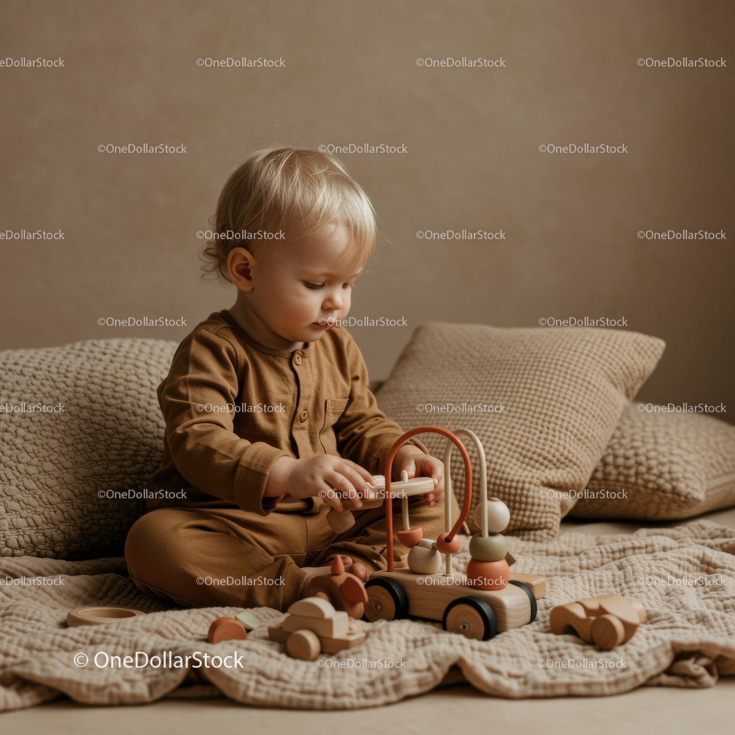 Toddler playing with wooden toys on cozy bed
