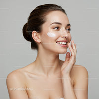 Beautiful Young Woman Applying Skincare Cream with a Bright Smile