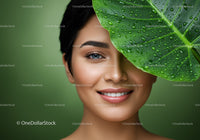 Smiling Woman with Green Leaf Close-Up Portrait with Lush Foliage
