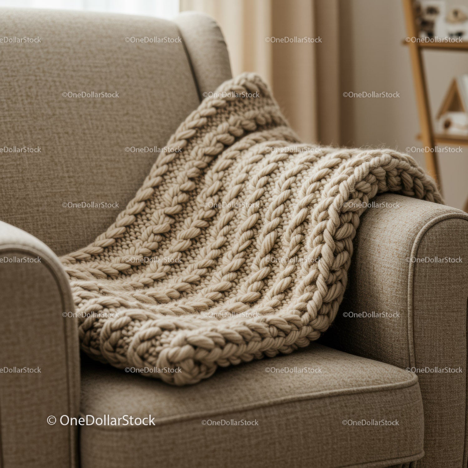 Cozy knitted blanket draped over beige armchair