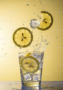 Refreshing lemon slices splashing into sparkling water glass