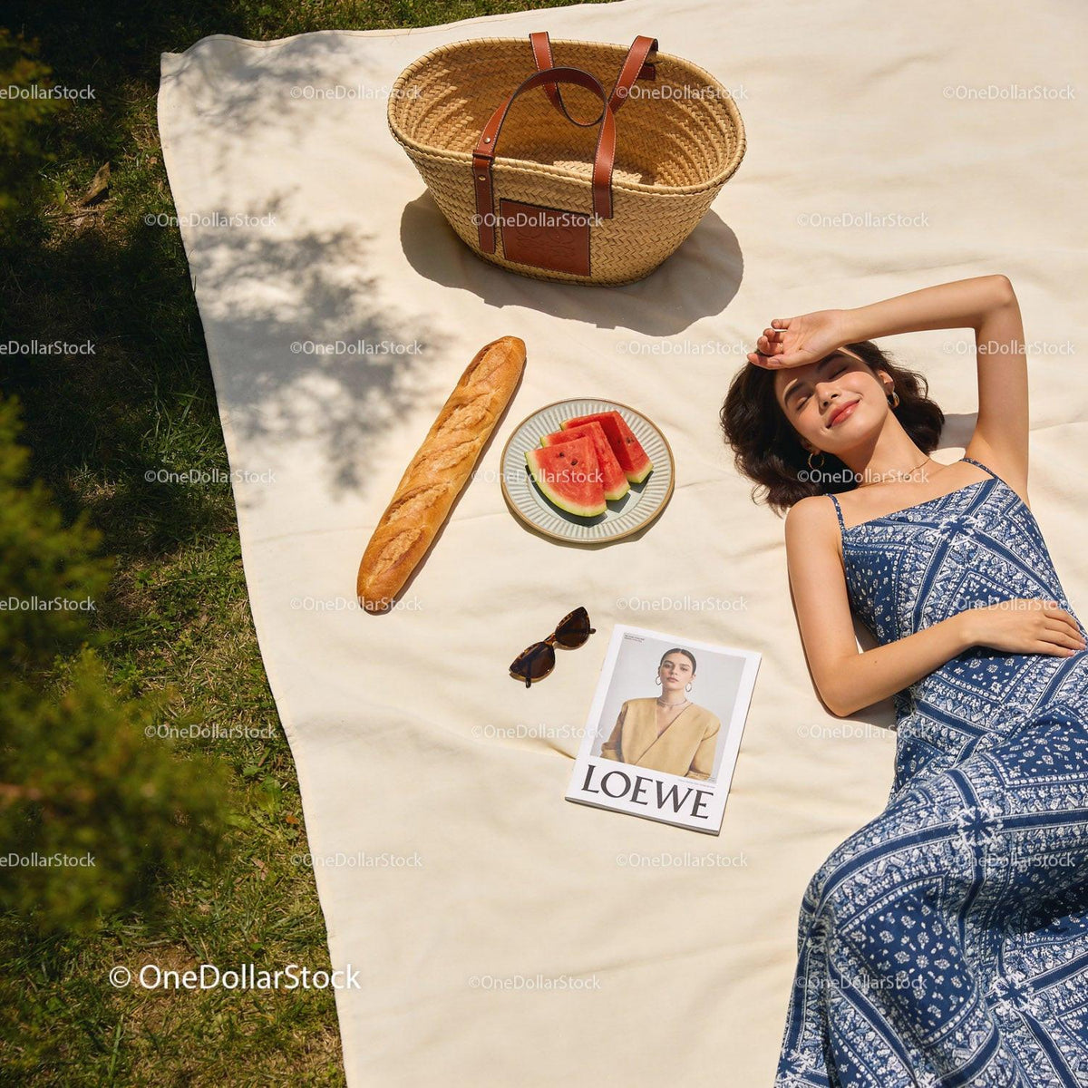 Woman Relaxing on Picnic Blanket with Watermelon and Bread