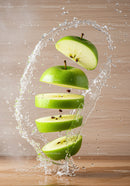 Fresh green apple slices surrounded by water splash
