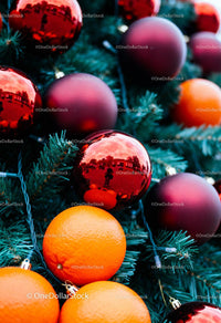 Festive Close-Up of Oranges and Red Christmas Ornaments