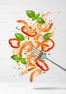Fresh shrimp salad ingredients with basil and pepper splash