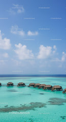 Overwater Bungalows in Turquoise Ocean with Blue Sky and Clear Water