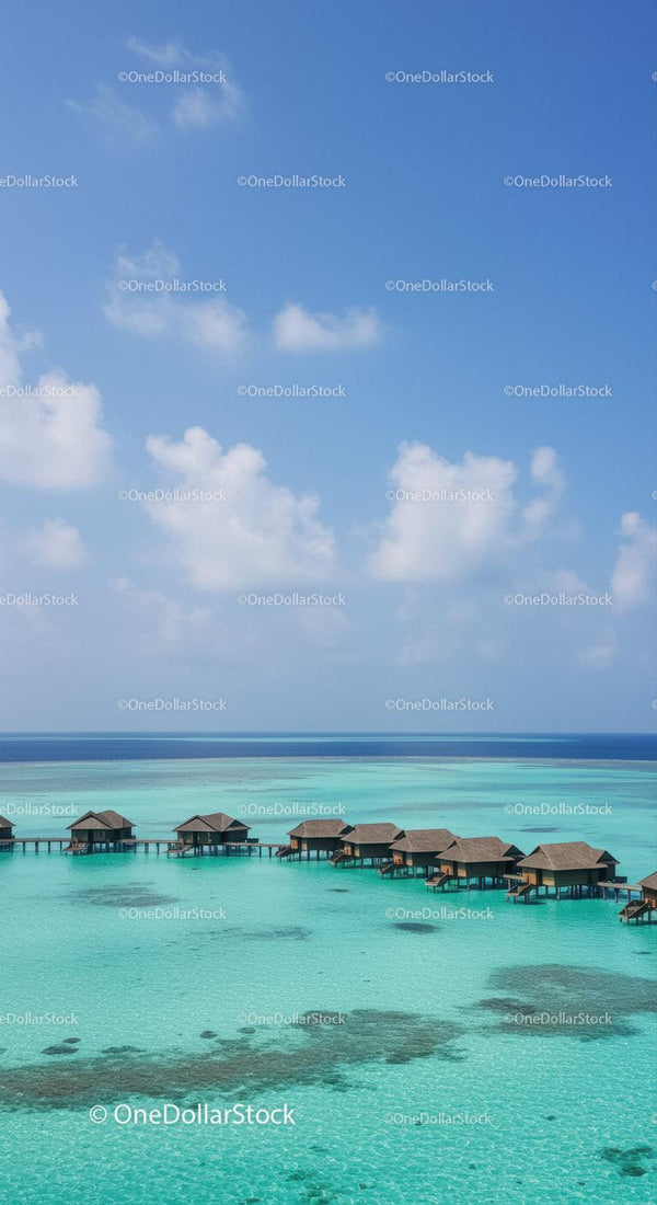 Overwater Bungalows in Turquoise Ocean with Blue Sky and Clear Water