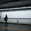 Underground Subway Station with Modern Tiled Walls and Commuter