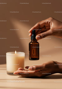 Essential Oil Dropper and Candle Creating a Relaxing Atmosphere