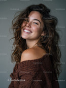 Joyful Woman with Curly Hair in Trendy Sweater Looking Over Shoulder