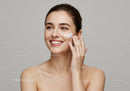 Portrait of a Happy Woman Applying Facial Cream for Skin Care