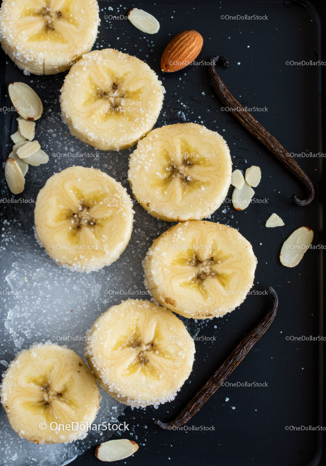 Sliced Bananas with Sugar and Vanilla Beans on Black Tray