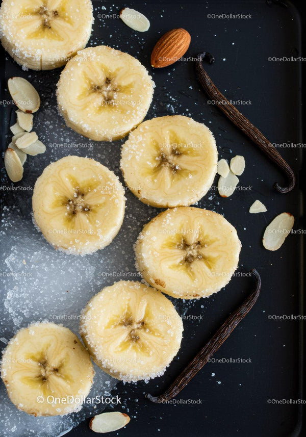 Sliced Bananas with Sugar and Vanilla Beans on Black Tray