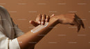 Close-Up of Hands Applying Body Lotion on Arm for Skin Moisturization