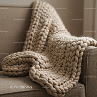 Chunky knit beige blanket draped over sofa armrest