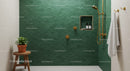 Modern bathroom with green tile and gold shower fixtures