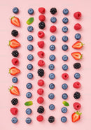 Assorted Fresh Berries and Mint Leaves on Pink Background