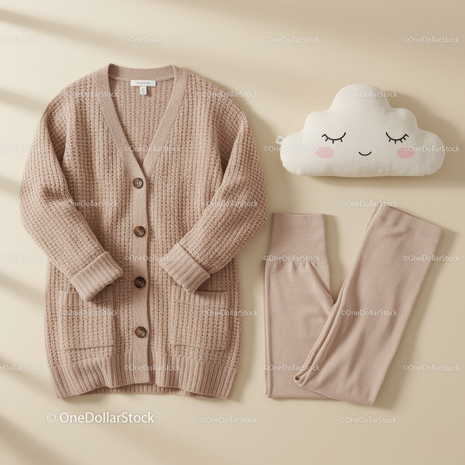 Cozy beige knit cardigan with soft leggings and pillow