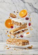 Healthy granola bars with yogurt and fresh orange slices