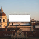 Large Blank Billboard Above Urban Rooftops at Sunset
