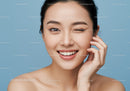 Young Smiling Woman with Beautiful Skin Over Blue Background