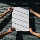 Two People Holding Blank White Paper Outdoors
