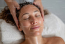 Relaxing Facial Massage with Woman Lying Peacefully in Spa