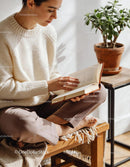 Calm woman reading a book in a cozy sunlit corner