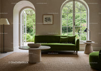 Elegant living room with green velvet sofa and garden view