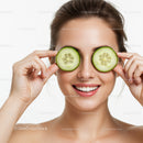 Young Woman Holding Cucumber Slices in Front of Her Eyes for Skincare