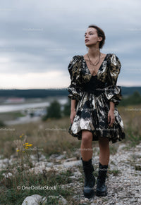 Stylish Woman in Fashionable Dress Standing Outdoors in Dramatic Sky