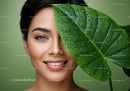Smiling Woman with Tropical Green Leaf and Water Droplets