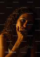 Thoughtful woman illuminated by warm soft light
