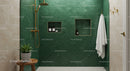 Modern bathroom with green tiles and gold fixtures