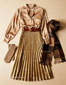 Elegant pleated gold skirt with satin blouse and accessories