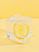 Ice Cube with Lemon Slice on Yellow Background