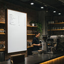 Barista preparing coffee behind stylish cafe counter