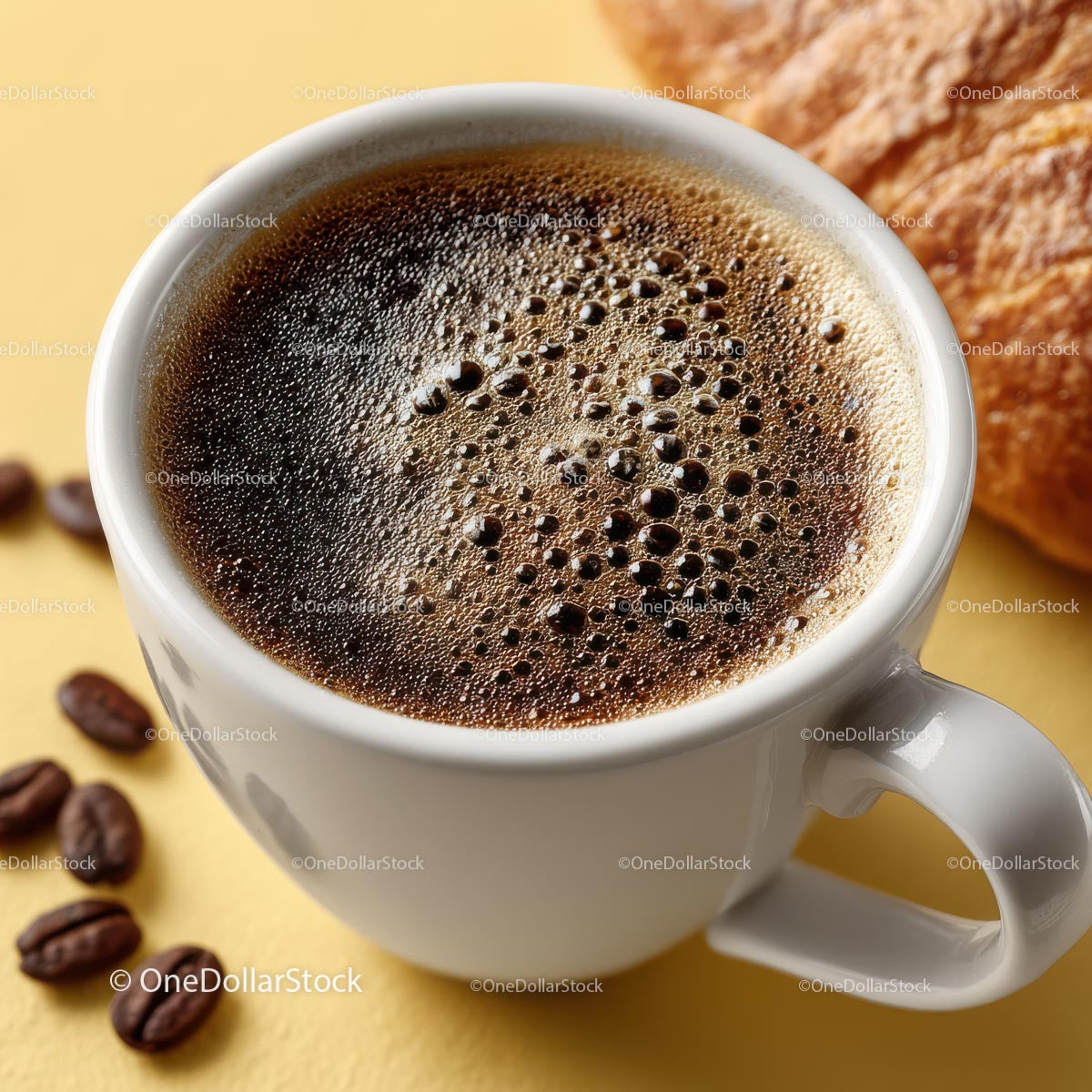 Świeżo parzona kawa w filiżance z croissantem na stole