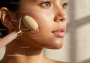 Close-Up of Young Woman Using Facial Roller for Skin Rejuvenation