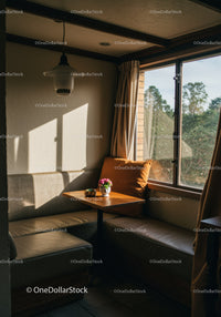 Sunlit Cozy Corner with Wooden Table and Flower Vase in Living Room