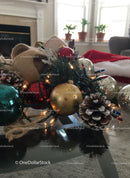 Festive Christmas decorations with lights on glass table