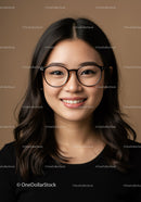 Young Asian Woman in Glasses Smiling for Professional Portrait