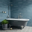 Vintage clawfoot bathtub in modern blue tiled bathroom