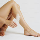 Elegant Female Legs with White Feather in Soft Minimalist Scene