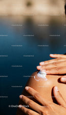Applying Skincare Cream to Smooth Shoulder in Natural Light