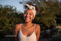 Bright Smiling Woman Outdoor Portrait with Sunlit Background